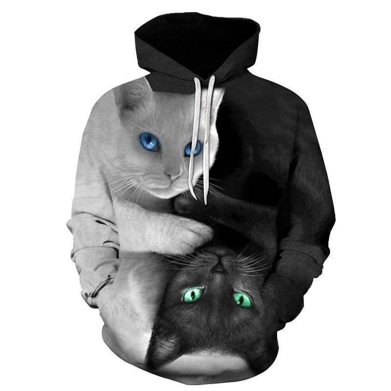 A black and white hooded sweatshirt featuring a large 3D graphic of two cats, one white with blue eyes and one black with green eyes, in a symmetrical design on a white background.