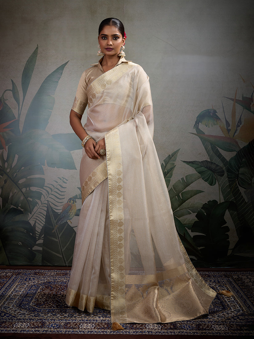 Off white soft tissue silk saree paired with a matching tissue brocade blouse.
