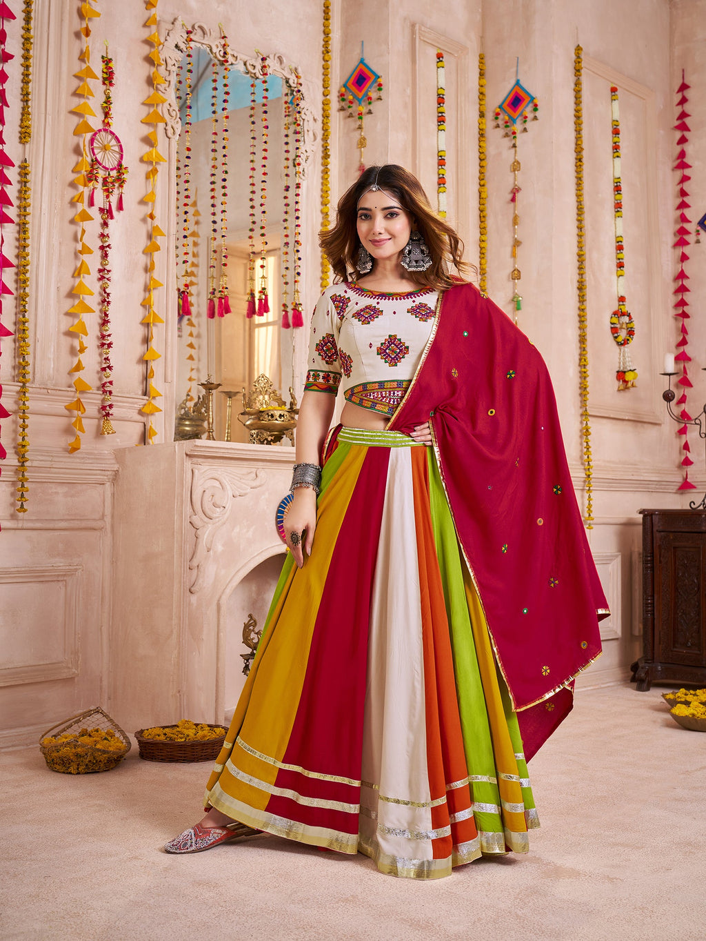 Multicolor Navratri Lehenga Choli set featuring a geometric print and an intricate mirror-work Kutchi jacket.