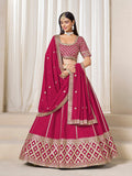 Model wearing a Rani Pink Art Silk A-Line Lehenga Choli set with exquisite embroidery for wedding wear
