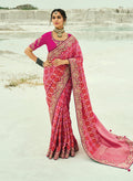 Rani Pink Georgette Bandhej Saree with intricate embroidery and zari work