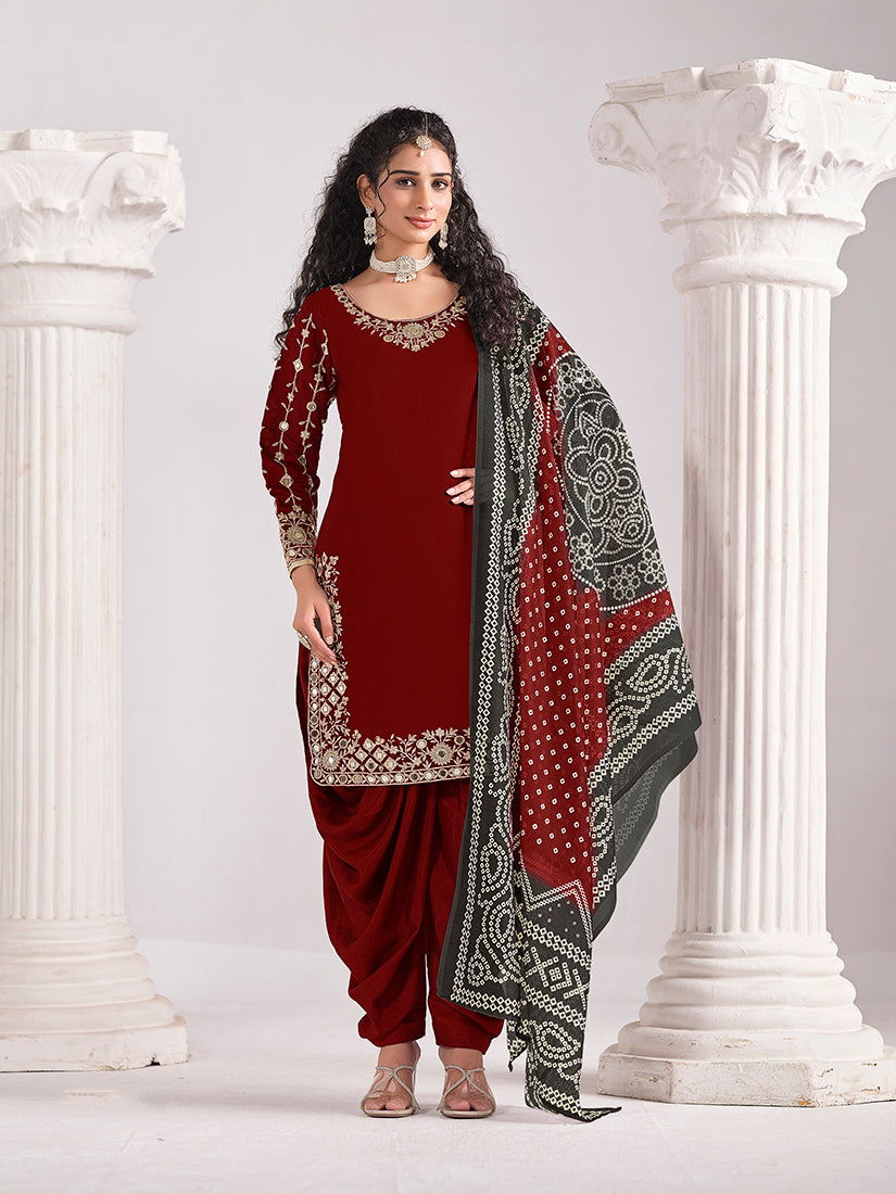 Woman wearing a maroon Chanderi silk salwar kameez with detailed mirror and zari embroidery work