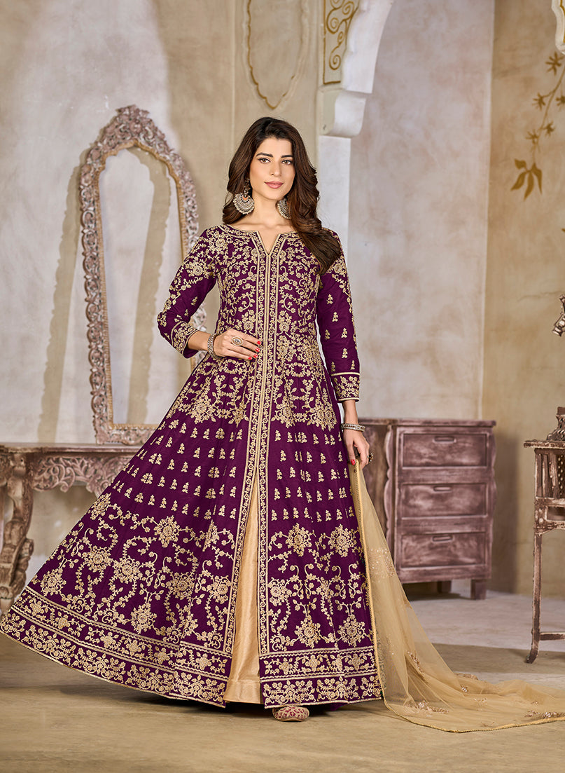 Purple art silk Anarkali salwar kameez featuring intricate zari embroidery and traditional aesthetic.