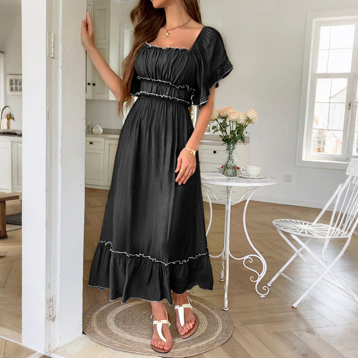 Woman wearing a high-waist mid-length vacation dress with lettuce-edge details