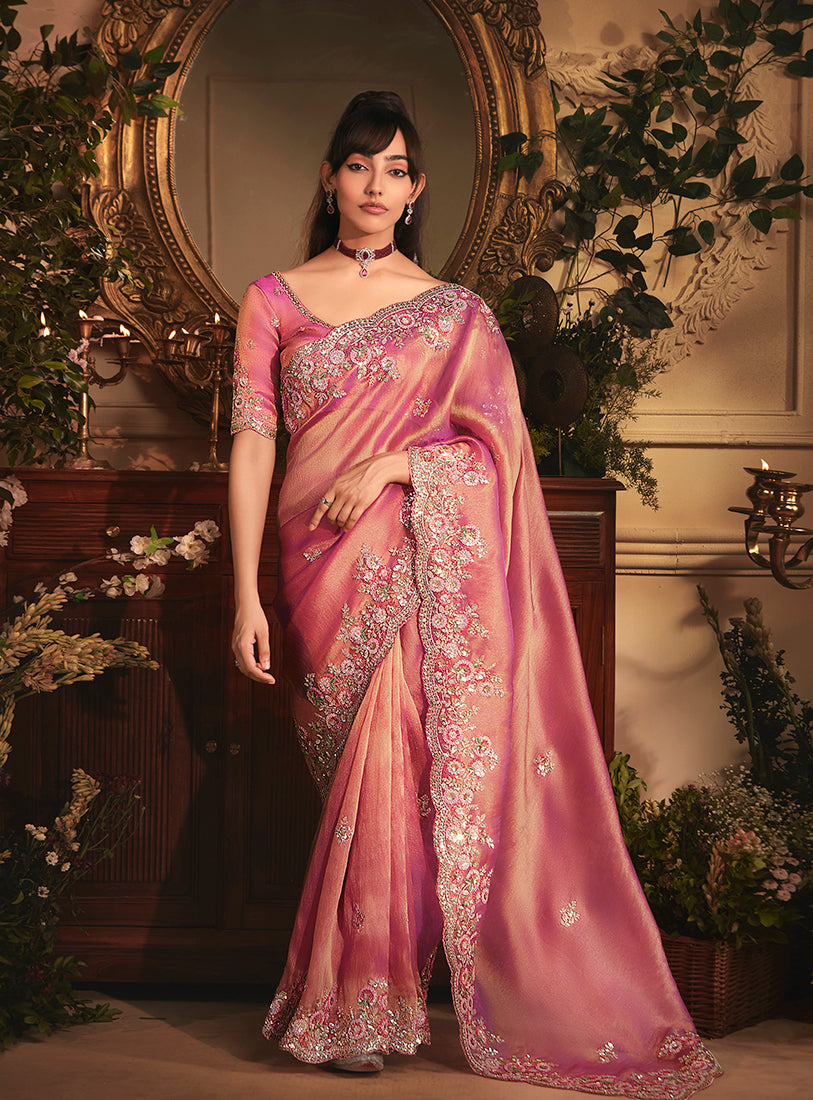 Pink tissue organza saree featuring intricate butta work and heavy stone border.