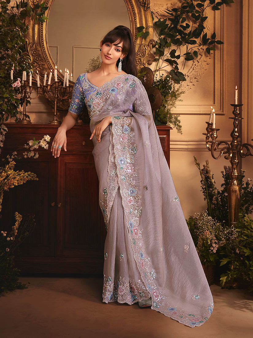 Light lilac tissue organza saree with all-over butta work and a heavy stone-embellished border