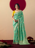 Sea green viscose silk saree featuring detailed zari weaving and designer tassels on the pallu.