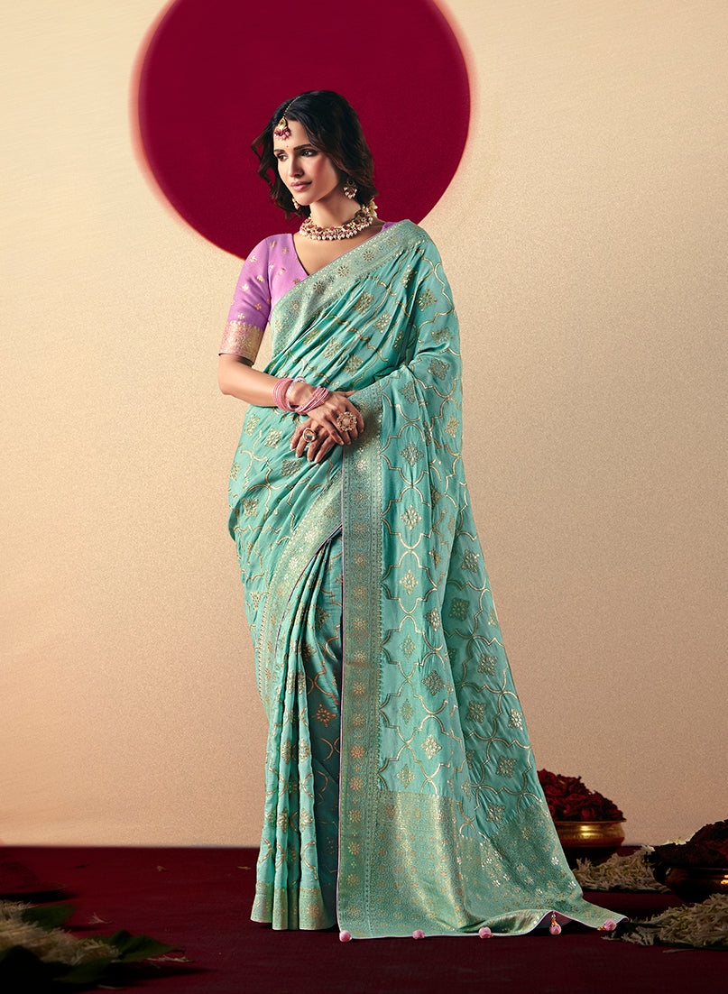 An aqua blue viscose silk saree with detailed zari weaving and decorative pallu tassels.