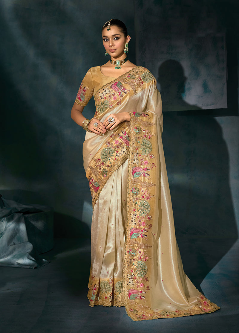 Cream silk blend saree featuring heavy mirror and cutdana moti embroidery