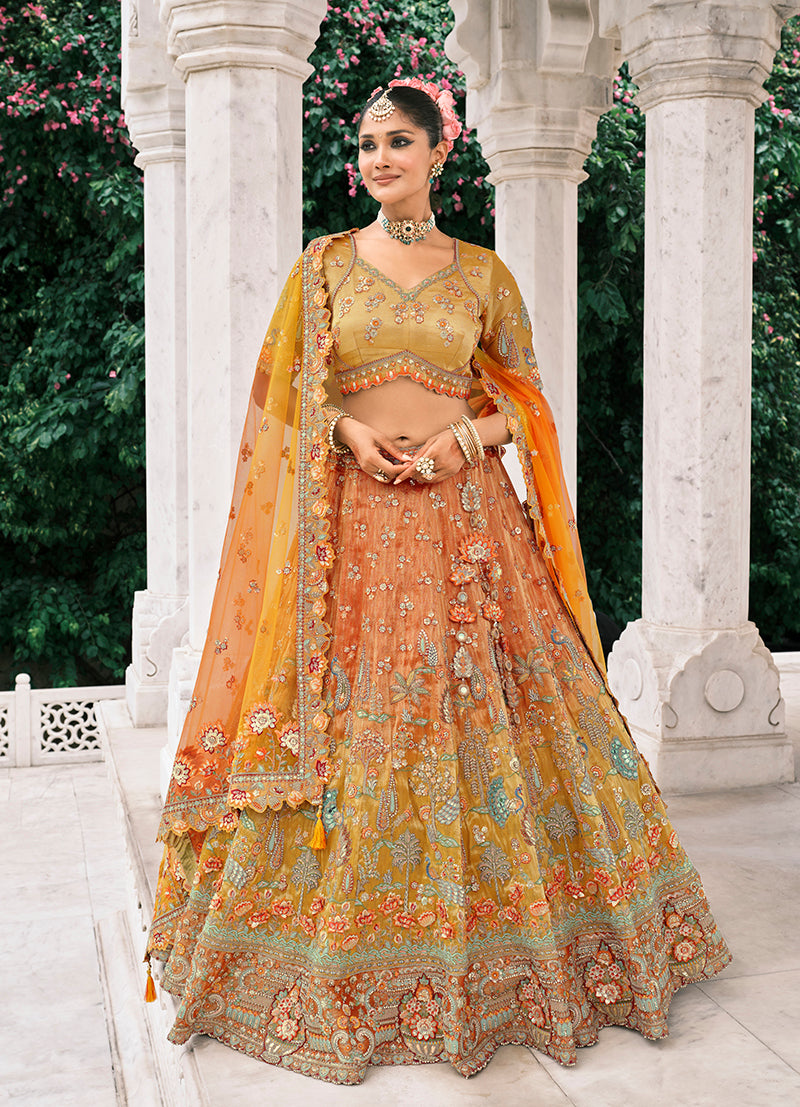 Rust orange and mustard yellow silk bridal lehenga with detailed sequins and embroidery work.
