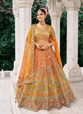 Rust orange and mustard yellow silk bridal lehenga with detailed sequins and embroidery work.