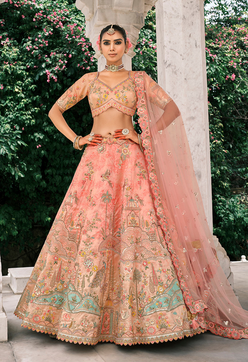 Peach silk bridal lehenga with thread embroidery and decorative stone work