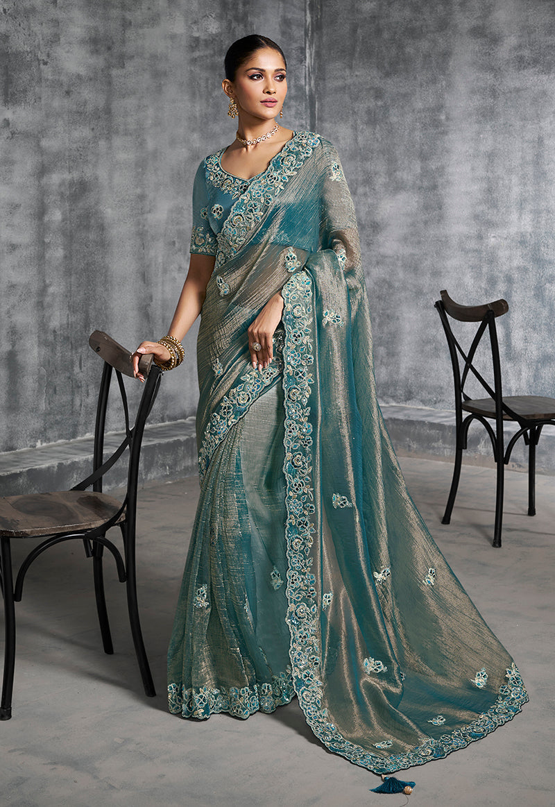 Teal blue tissue saree with detailed Resham and thread embroidery for ceremonial occasions