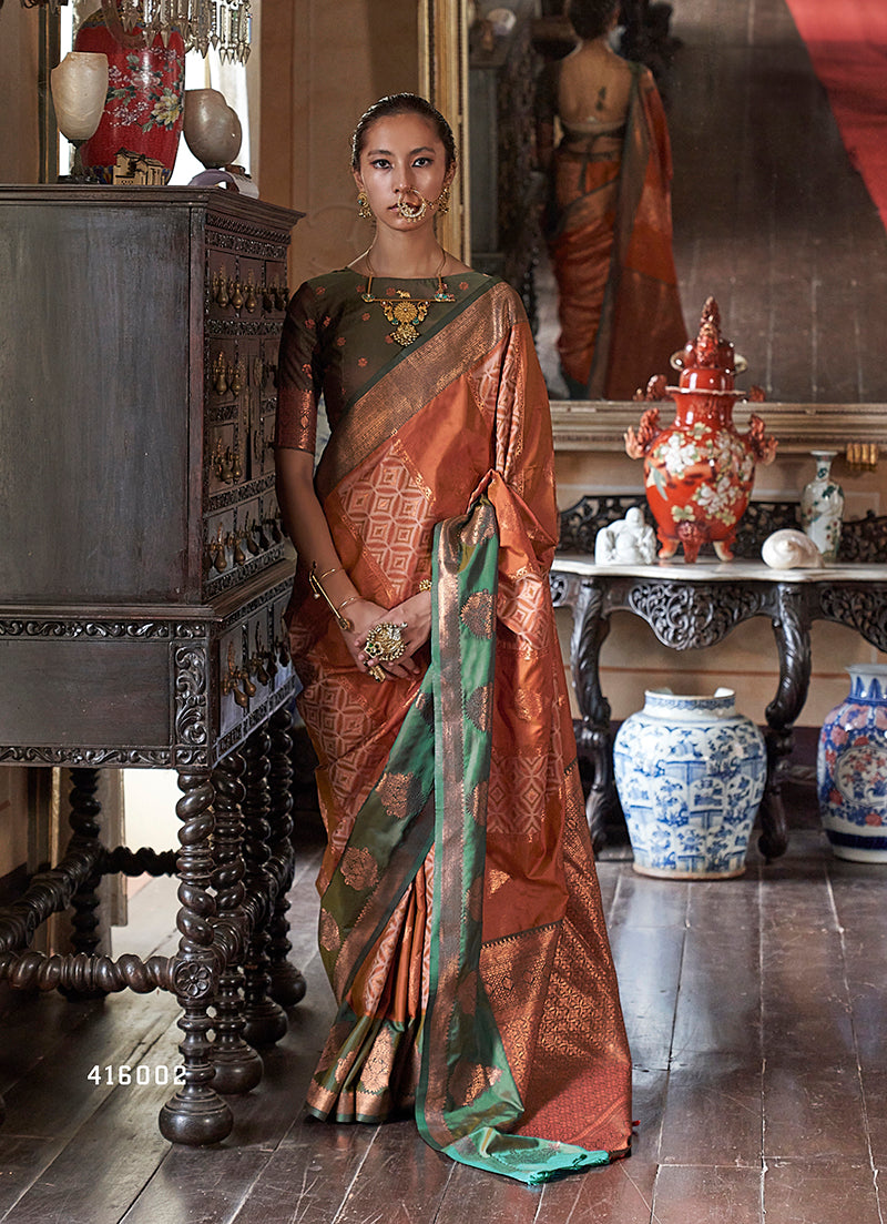 Rust silk saree with intricate gold zari weaving work for traditional ceremonies