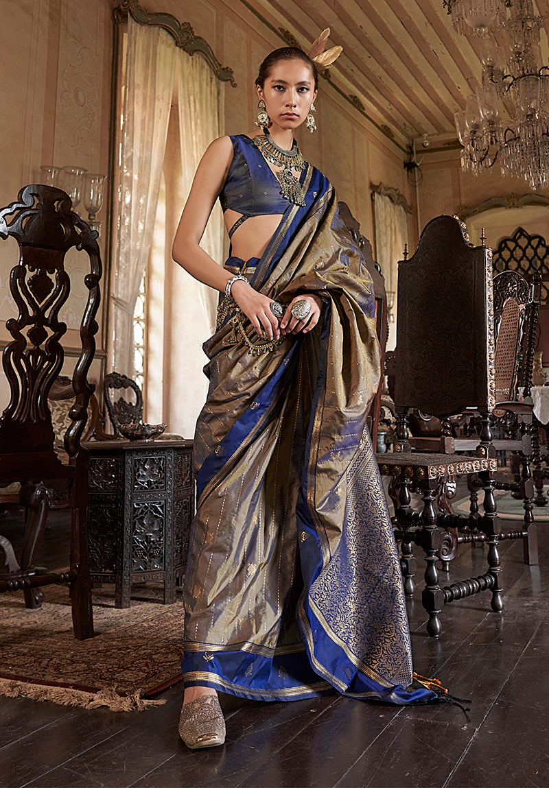 Model wearing a royal blue and golden Tussar silk saree with intricate zari weaving work