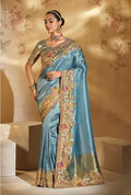 Sky blue silk blend saree adorned with intricate cut dana and moti embroidery, complete with a matching heavy-work blouse.