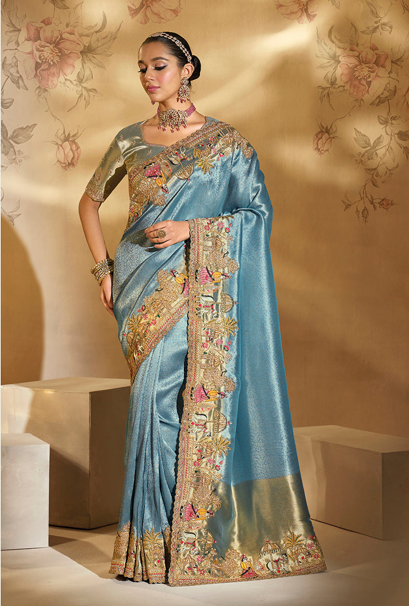 Sky blue silk blend saree adorned with intricate cut dana and moti embroidery, complete with a matching heavy-work blouse.