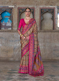 Beige and rani pink silk blend saree with traditional Patola print