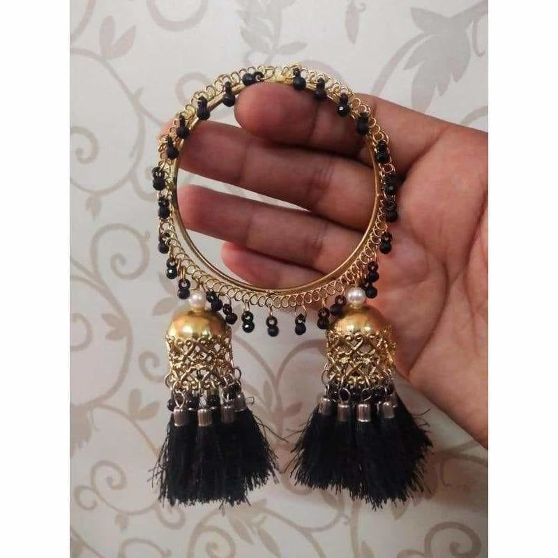Gold-tone bangles with black silk threads, pearls, and dangling jhumka charms