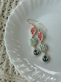 Nautical-themed multi-colored polymer clay earrings with gold accents.