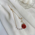 Close-up of a Joban Fashion red and white rose floral bracelet on a white background.