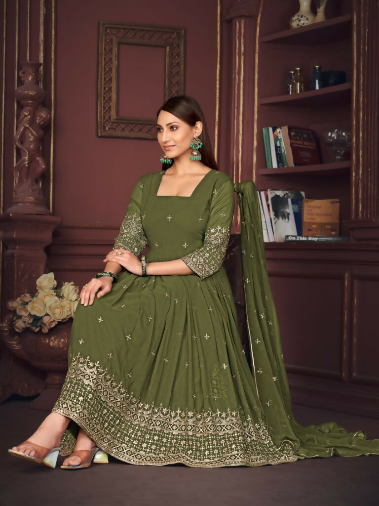 A woman wearing an olive green floor-length georgette Anarkali kurta with intricate embroidery and a matching dupatta.