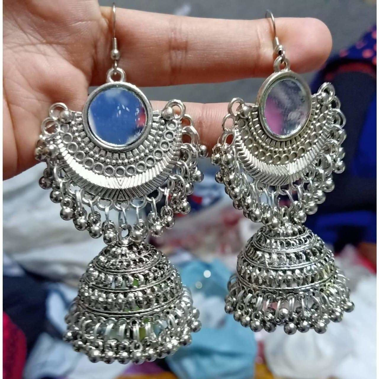 Afghani tribal jhumki earrings with oxidized finish, mirror accents, and hanging pearl details.