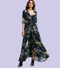 A woman wearing a navy blue floral print bohemian maxi dress with a button-down front and three-quarter sleeves.