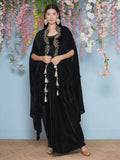 Model wearing a black velvet hand-embellished cape with matching inner and skirt