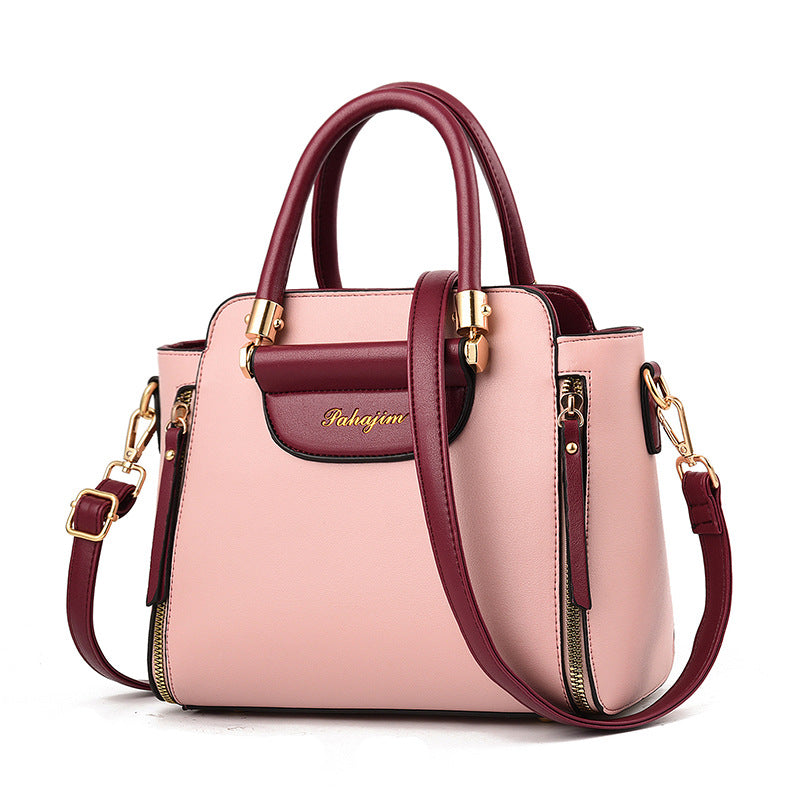 Stylish high-capacity leather-style bag with removable strap for parents on the go.