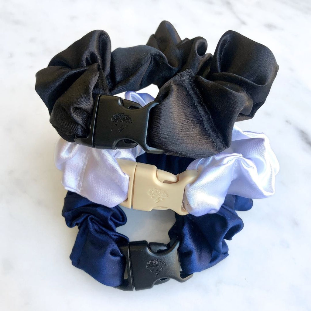3-pack of neutral-colored satin hair scrunchies in Industrial Black, Iceberg White, and Midnight Navy.