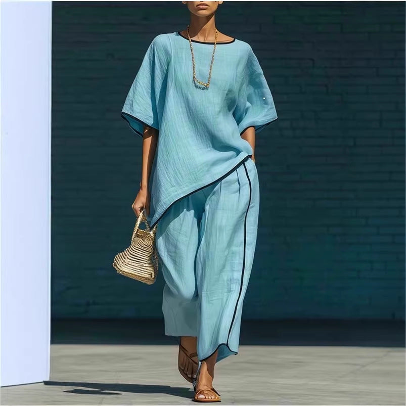 A woman wearing a matching loose light blue two-piece linen-blend set with short sleeves and wide-leg pants