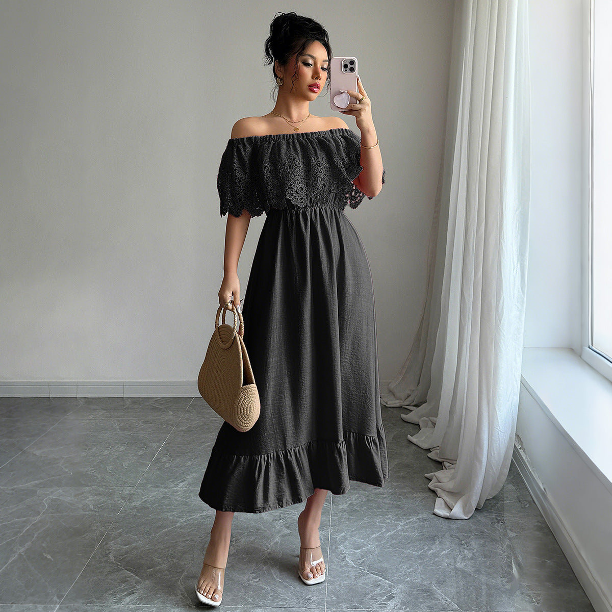 Model wearing an elegant black off-shoulder A-line dress in a romantic setting.