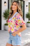 Kate puff sleeve cotton blouse in a vibrant pink, yellow, and blue floral pattern with striped collar and V-neck.