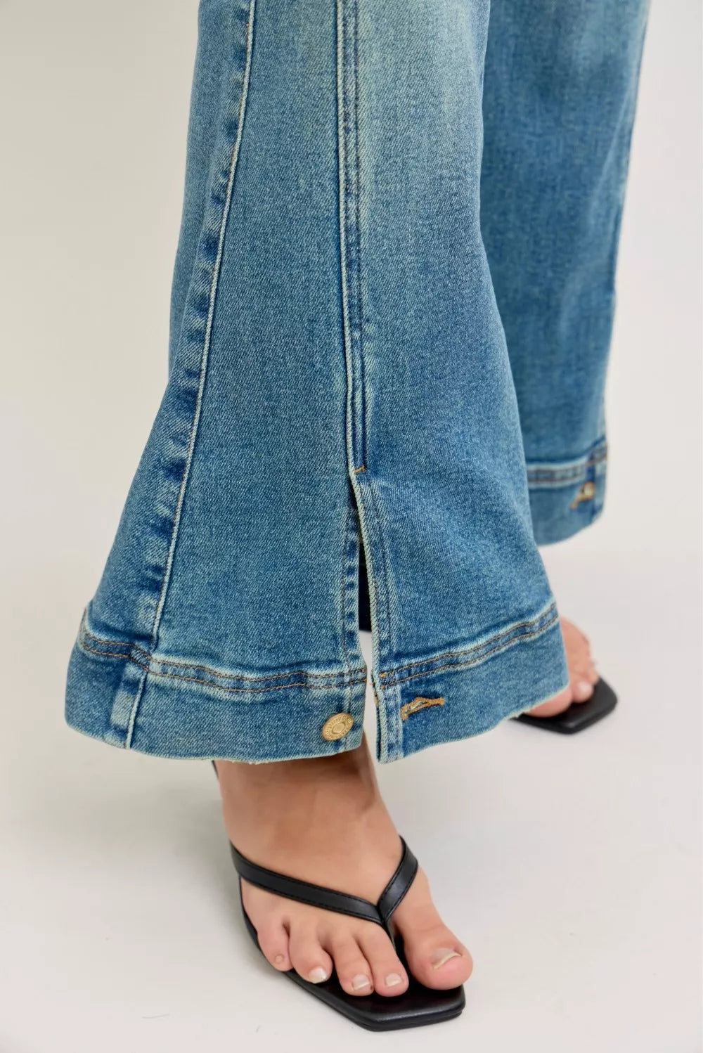 Close-up of blue jeans with a white background