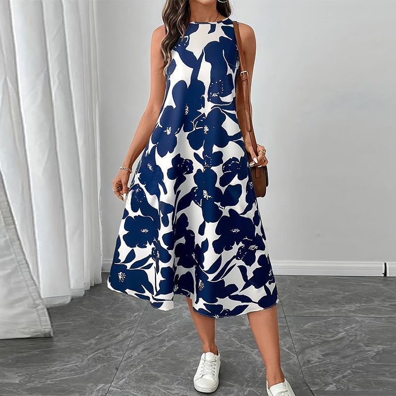 Woman wearing a floral print sleeveless A-line midi dress with button-front detail in navy and white.