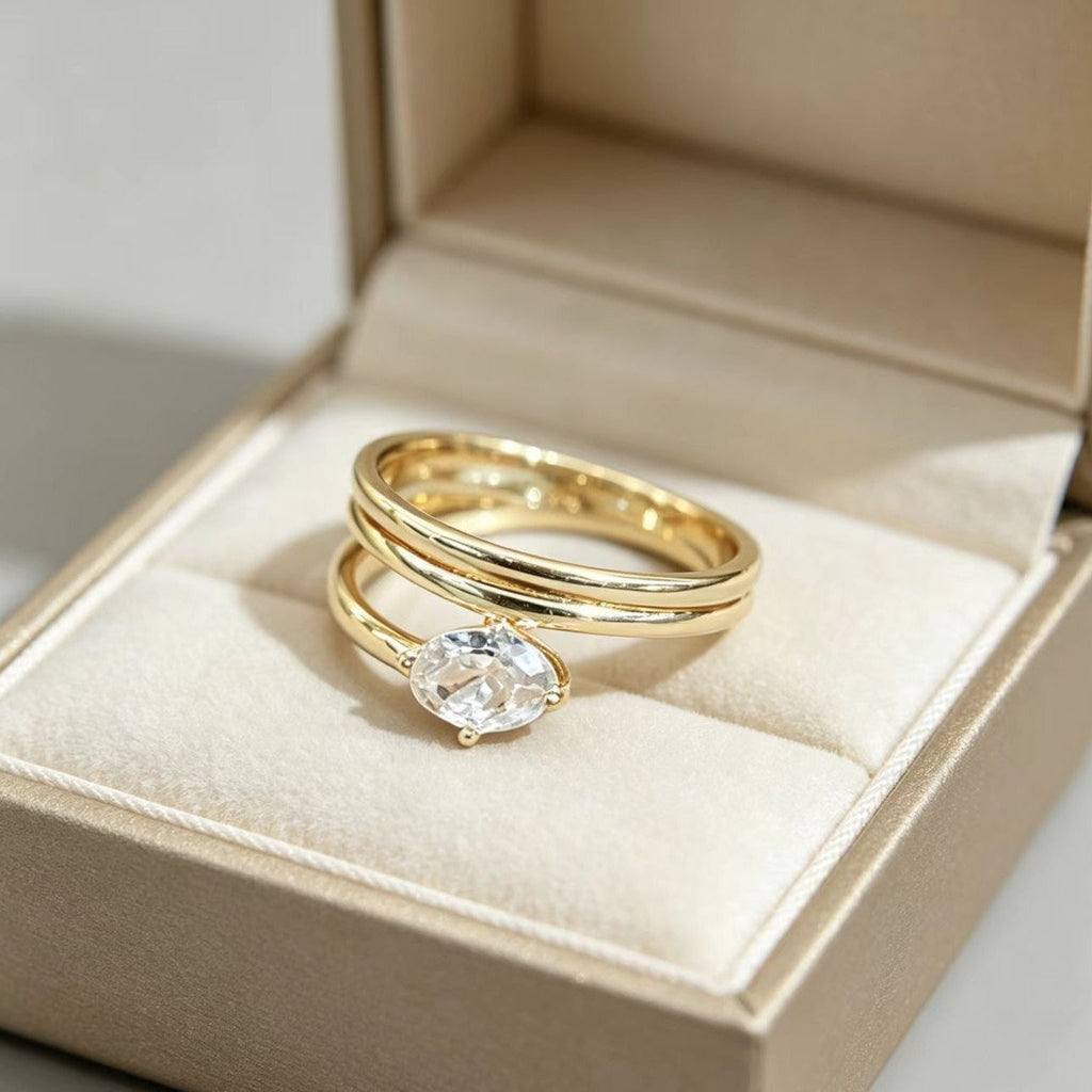 A gold-toned, asymmetrical geometric ring for women featuring sparkling zircon accents.