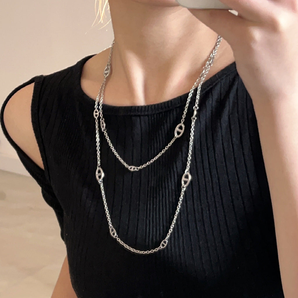 Vera Lux 18K gold plated titanium steel pig nose necklace on a white background