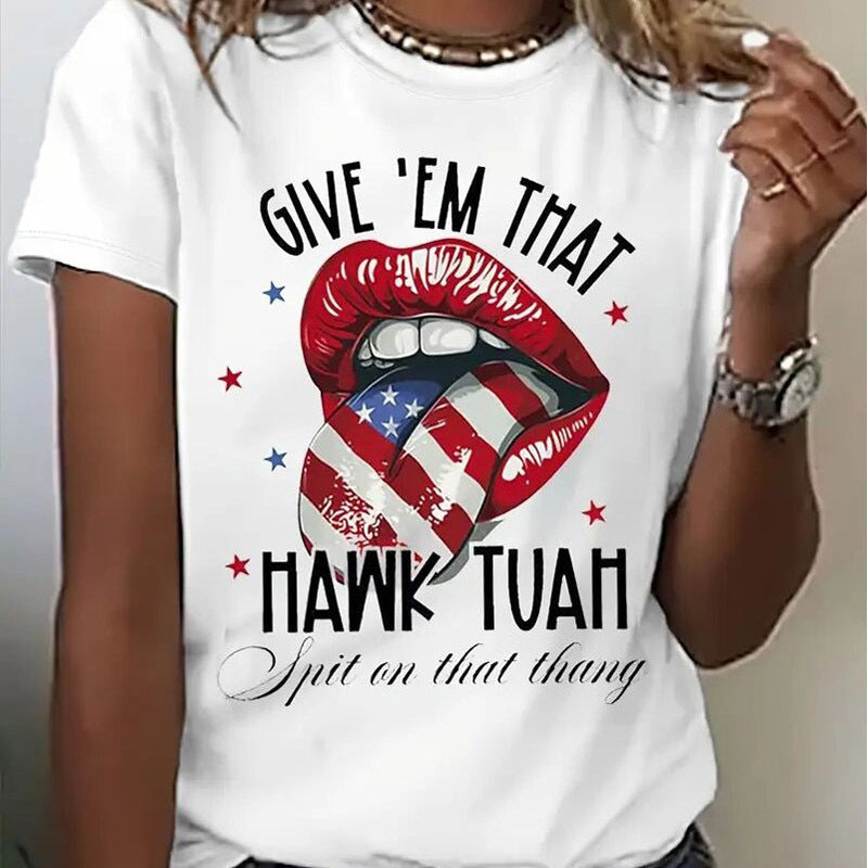 A woman wearing a white short-sleeve t-shirt with a graphic print of red lips containing an American flag pattern, featuring the text Give 'Em That Hawk Tuah.