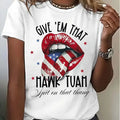 A woman wearing a white short-sleeve t-shirt with a graphic print of red lips containing an American flag pattern, featuring the text Give 'Em That Hawk Tuah.