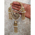 Gold-tone bracelet featuring white pearl embellishments and dangling jhumka chains