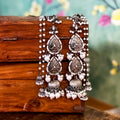 Oxidised black metal Jhumka earrings with ornate attached earchains