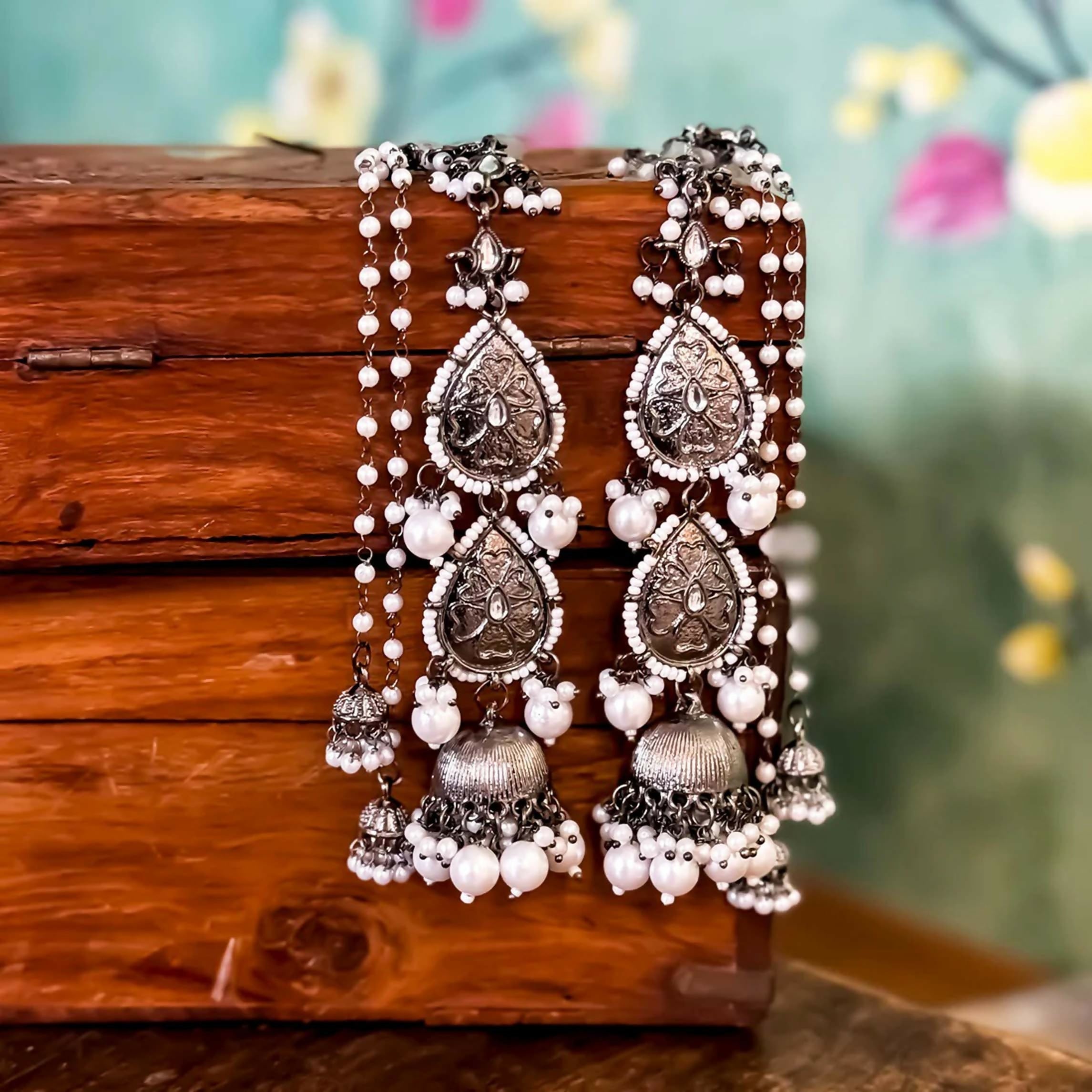 Oxidised black metal Jhumka earrings with ornate attached earchains