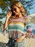 A woman wearing a hollow out knit bikini beach shirt featuring a striped pattern and round neck.