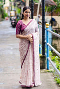 Purple georgette saree with Warli print, cutwork border, aari mirror work, and tie & dye Banarasi silk blouse.