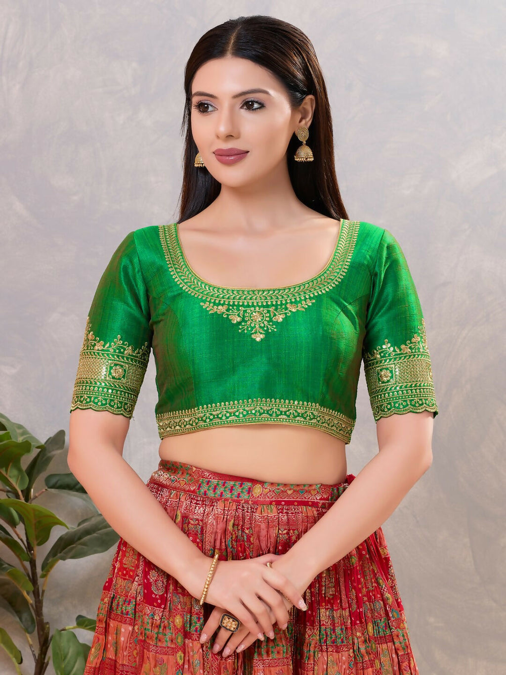 Vibrant green silk stitched blouse with round neck for ethnic sarees