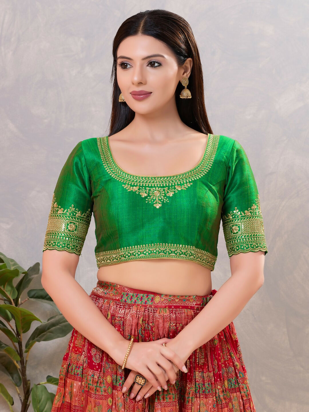 Vibrant green silk stitched blouse with round neck for ethnic sarees