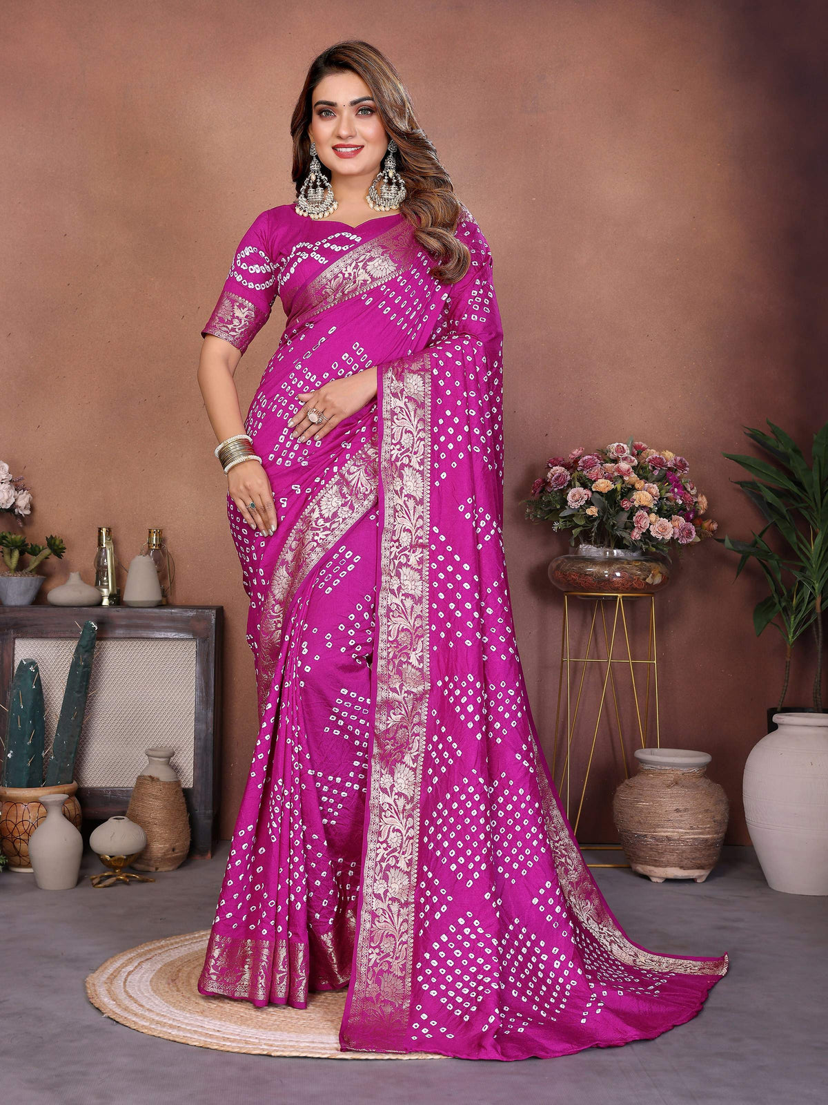 Close up of a Magenta Pure Dola Silk saree with intricate handmade Bandhej detailing.