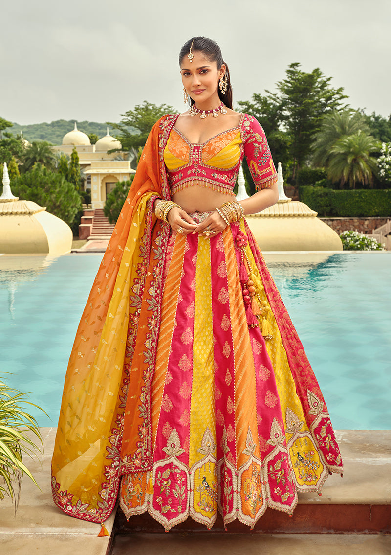 Woman wearing a heavy embroidered rani pink silk lehenga choli with multicolored accents