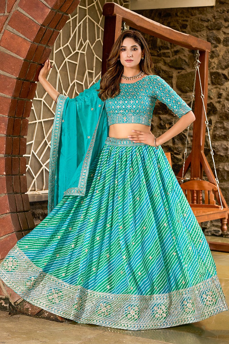 Turquoise Leheriya printed faux georgette lehenga choli with embroidery.